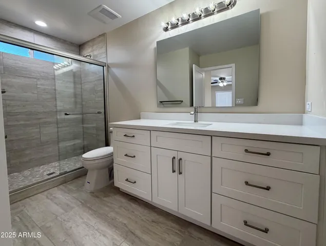 a bathroom with a shower and a toilet