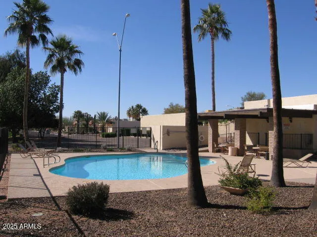 a swimming pool with outdoor seating and yard