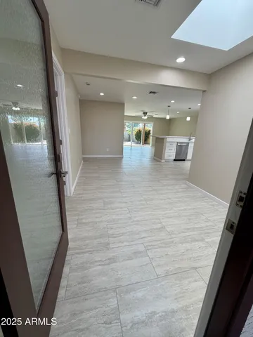 a kitchen with a sink wooden floor and stainless steel appliances