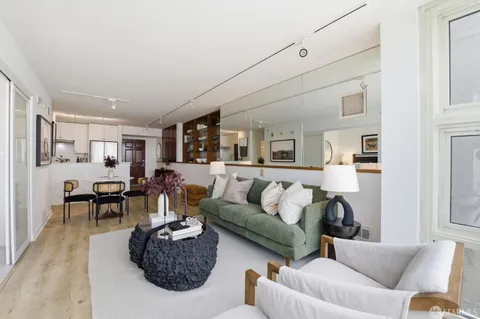 a dining room with furniture and wooden floor
