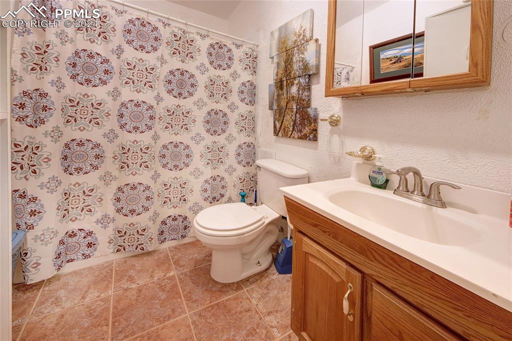 68 Valley Road Divide, CO 80814 - Photo 24 of 38 Bathroom with toilet, vanity, and tile patterned floors