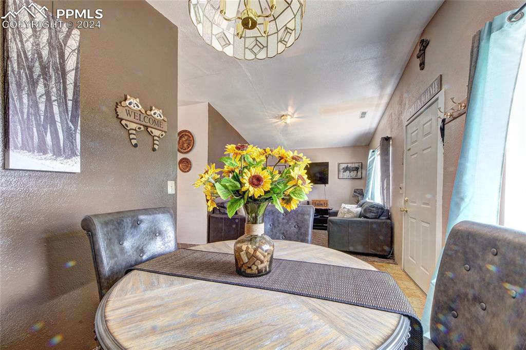 68 Valley Road Divide, CO 80814 - Photo 27 of 38 Dining area with a notable chandelier