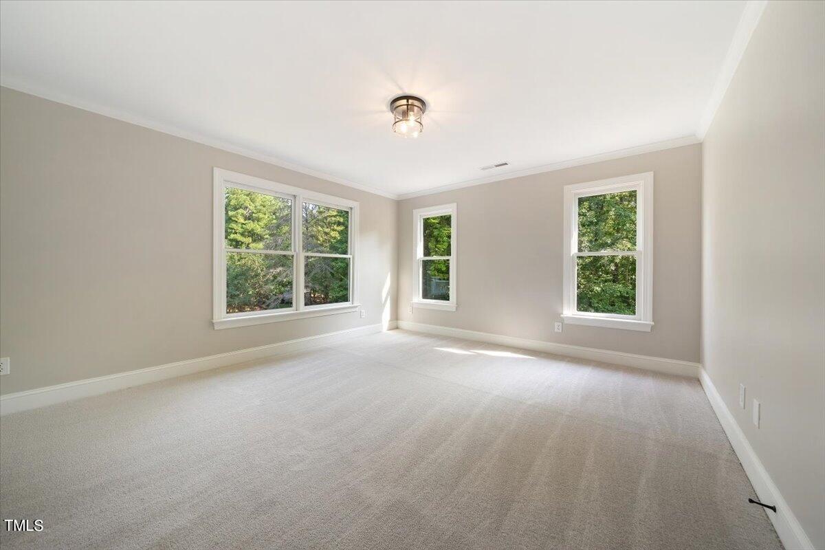 6300 Swallow Cove Lane Raleigh, NC 27614 - Photo 34 of 67 an empty room with windows and a ceiling fan