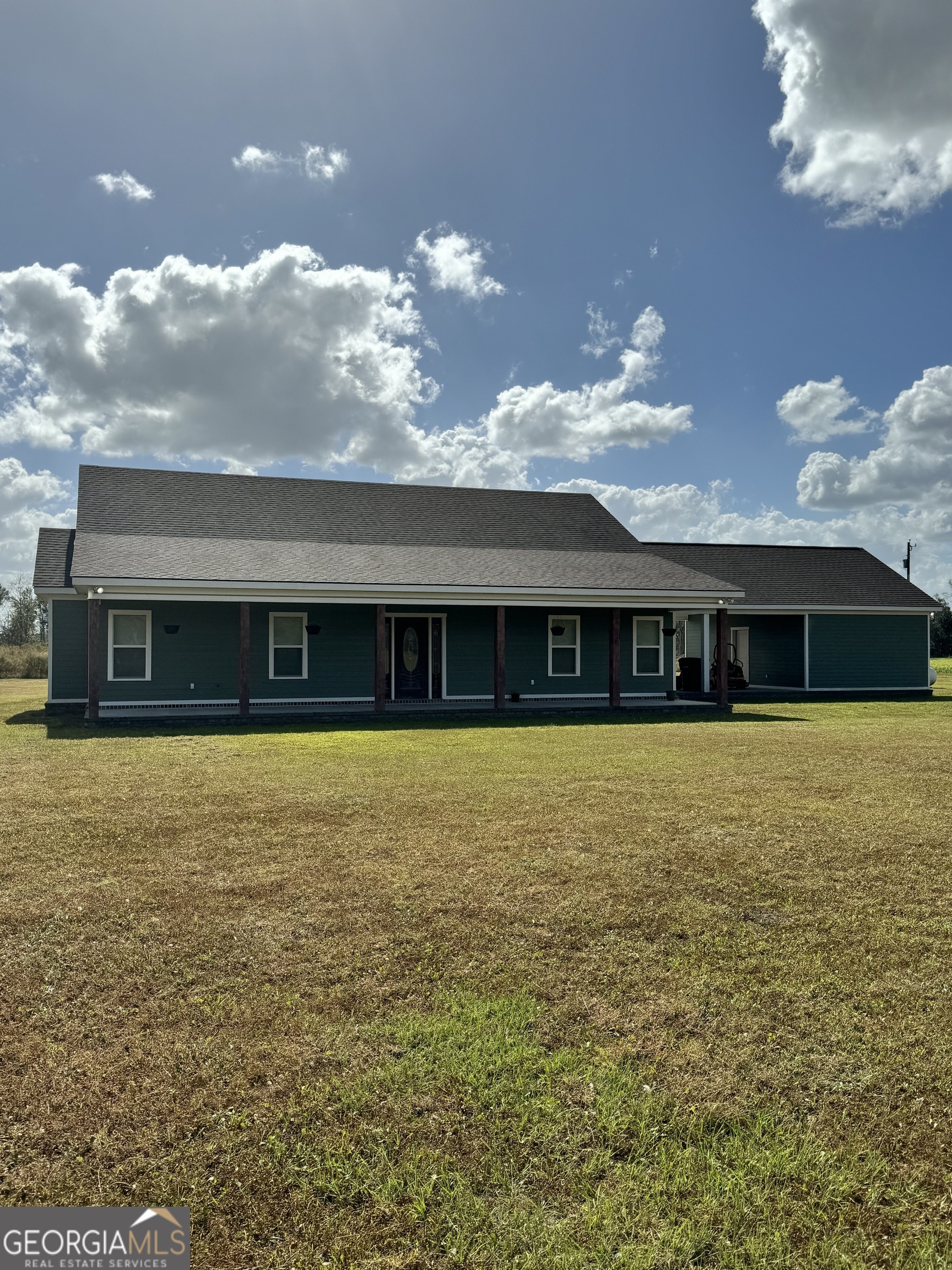 a front view of a house next to a yard