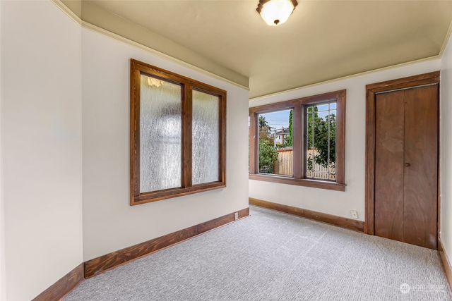 an empty room with windows and closet