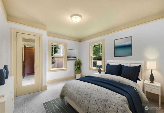 a bedroom with a large bed and a window