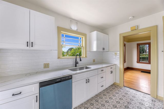 a kitchen with a sink cabinets and window