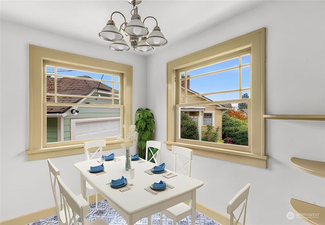 a view of a dining room with furniture a chandelier and wooden floor