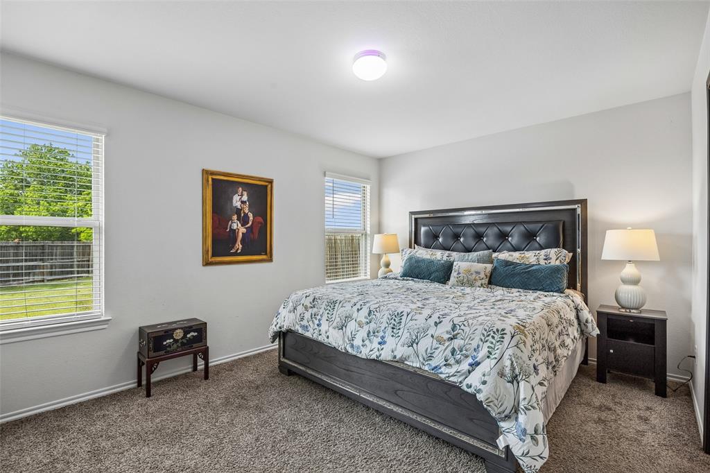802 Rustic Way Royse City, TX 75189 - Photo 26 of 38 a bedroom with a bed and a lamp