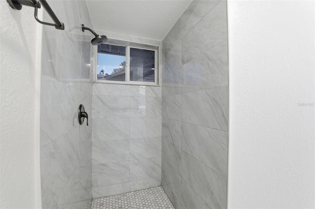 12515 Shadow Ridge Boulevard Hudson, FL 34669 - Photo 19 of 43 a bathroom with a shower