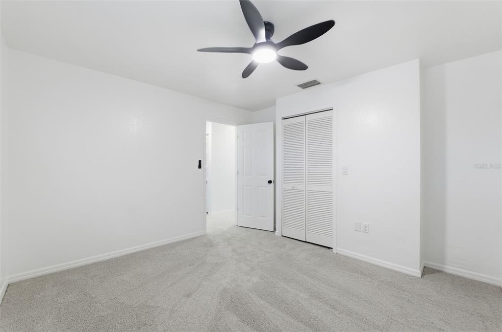 12515 Shadow Ridge Boulevard Hudson, FL 34669 - Photo 20 of 43 an empty room with a ceiling fan and a window