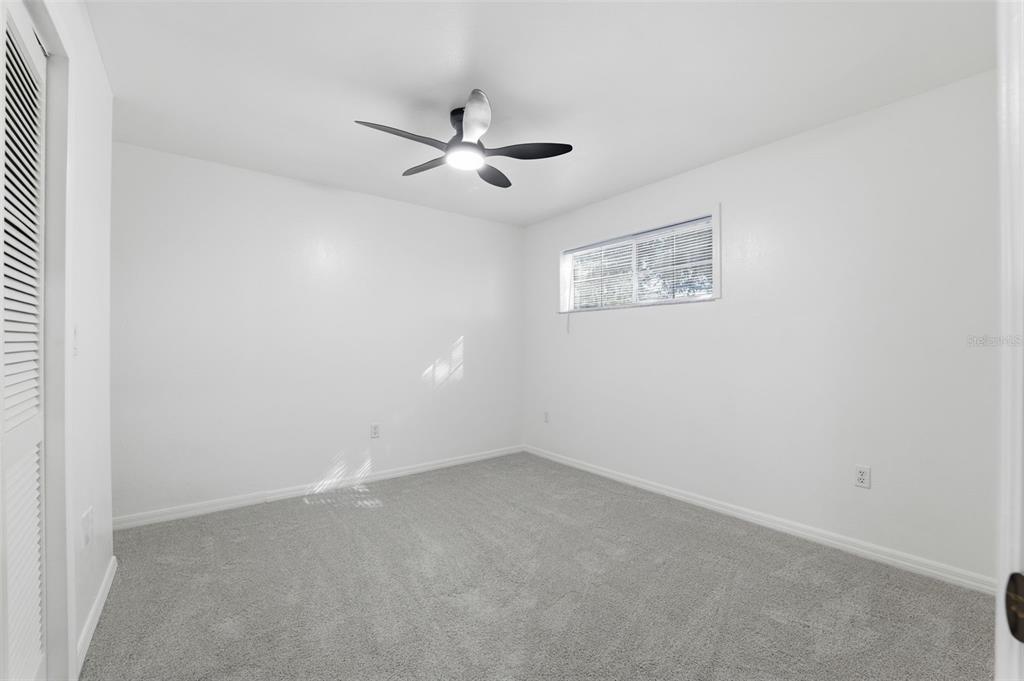 12515 Shadow Ridge Boulevard Hudson, FL 34669 - Photo 21 of 43 an empty room with a fan & a window
