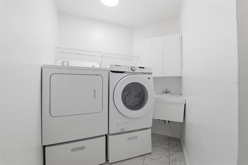 12515 Shadow Ridge Boulevard Hudson, FL 34669 - Photo 26 of 43 a utility room with dryer and washer