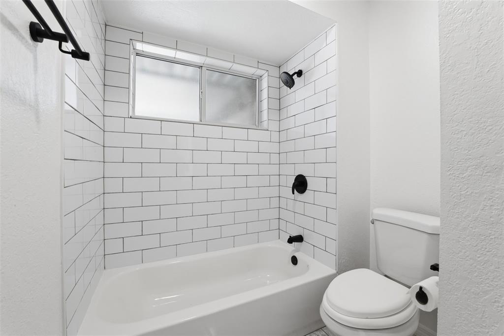 12515 Shadow Ridge Boulevard Hudson, FL 34669 - Photo 27 of 43 a bathroom with a bathtub shower and toilet