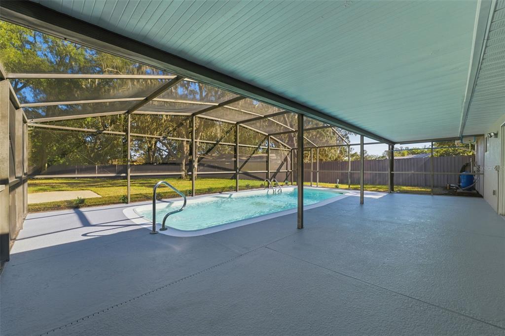 12515 Shadow Ridge Boulevard Hudson, FL 34669 - Photo 32 of 43 a view of a swimming pool with a porch