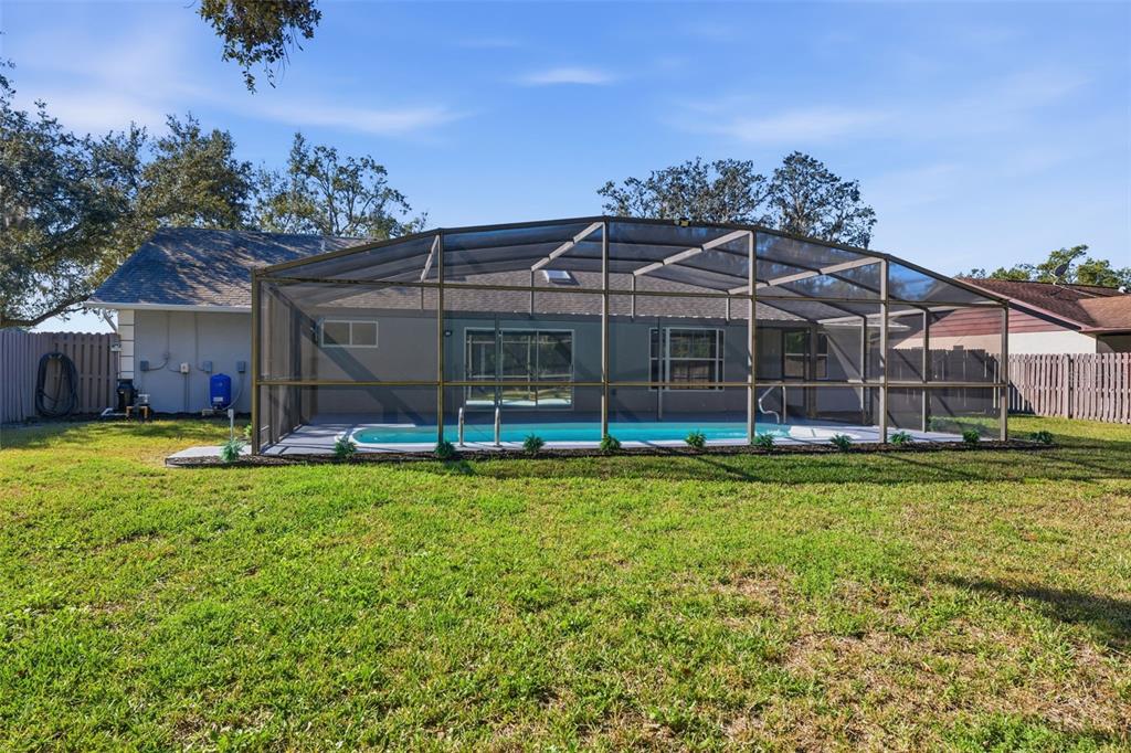12515 Shadow Ridge Boulevard Hudson, FL 34669 - Photo 37 of 43 a view of a house with a backyard porch and sitting area