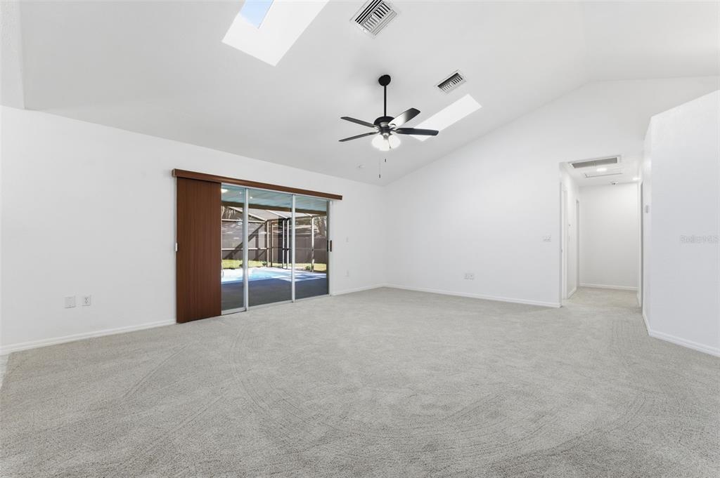 12515 Shadow Ridge Boulevard Hudson, FL 34669 - Photo 7 of 43 a view of an empty room with a window