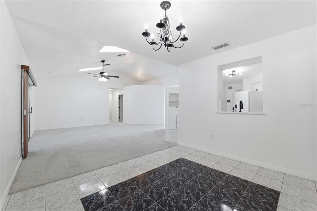 12515 Shadow Ridge Boulevard Hudson, FL 34669 - Photo 8 of 43 a view of a hallway with a chandelier
