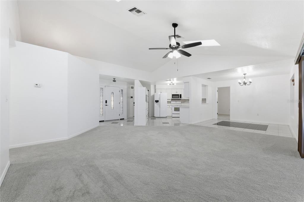 12515 Shadow Ridge Boulevard Hudson, FL 34669 - Photo 9 of 43 a view of a big room with chandelier fan and windows