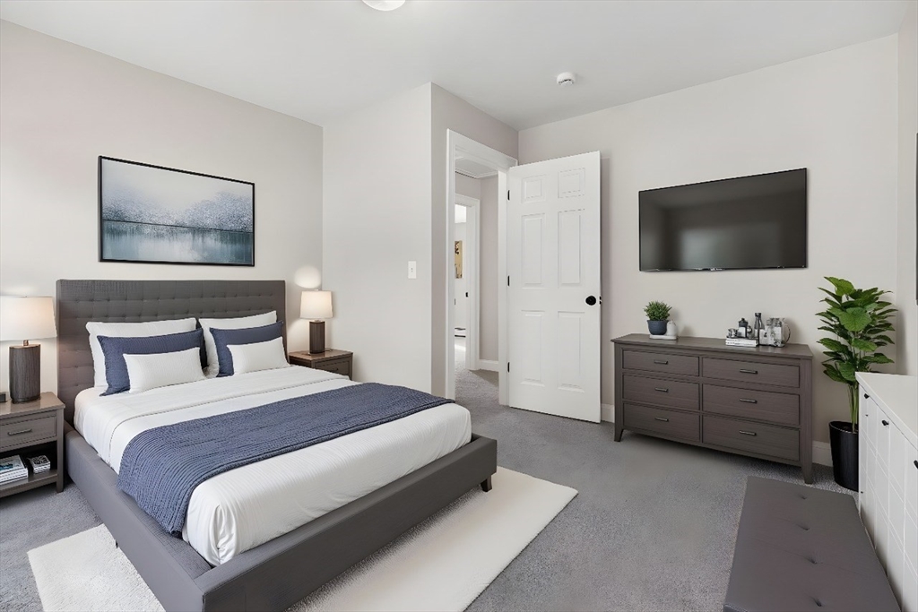 30 Foster Court Gardner, MA 01440 - Photo 19 of 37 a spacious bedroom with a bed and a flat screen tv