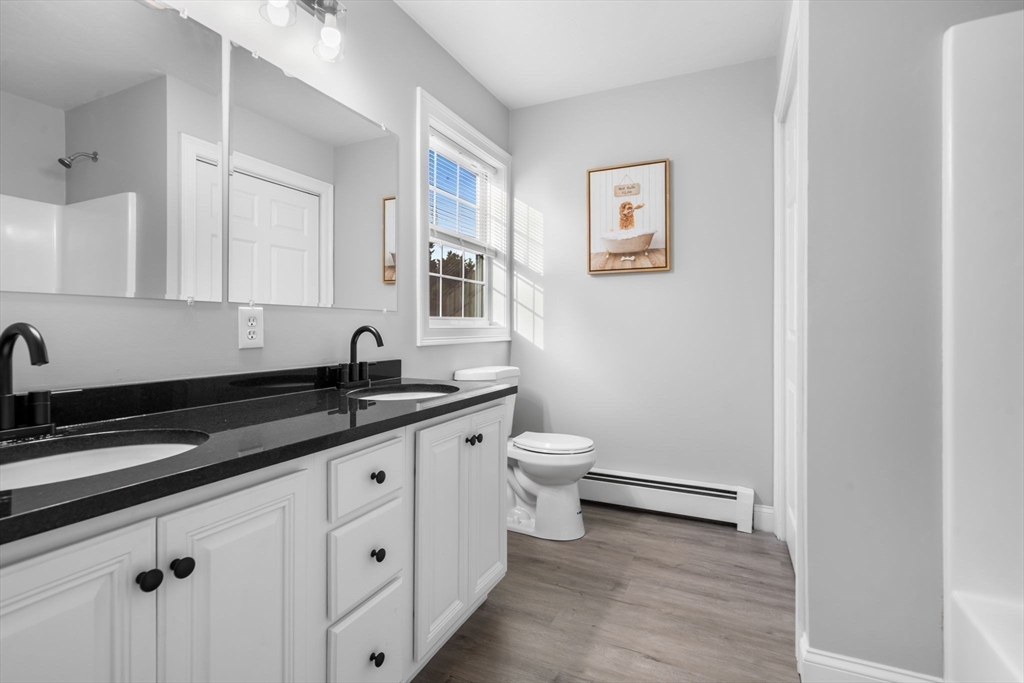 30 Foster Court Gardner, MA 01440 - Photo 21 of 37 a spacious bathroom with a granite countertop sink a toilet and a mirror