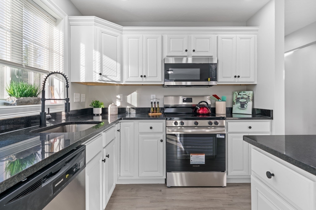 30 Foster Court Gardner, MA 01440 - Photo 10 of 37 a kitchen with white cabinets and appliances