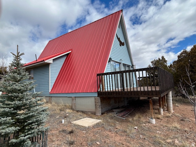 45720 Airport Road Fruitland, UT 84027 - Photo 17 of 22 View of side of home featuring a wooden deck and a metal roof