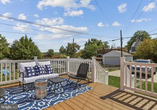 a roof deck with wooden floor and fence