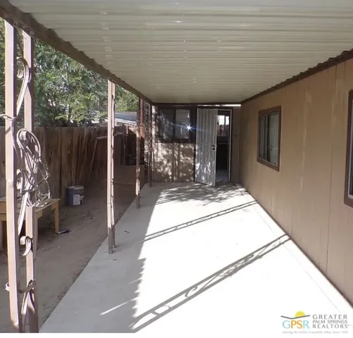 a view of a hallway with a large window and chandelier