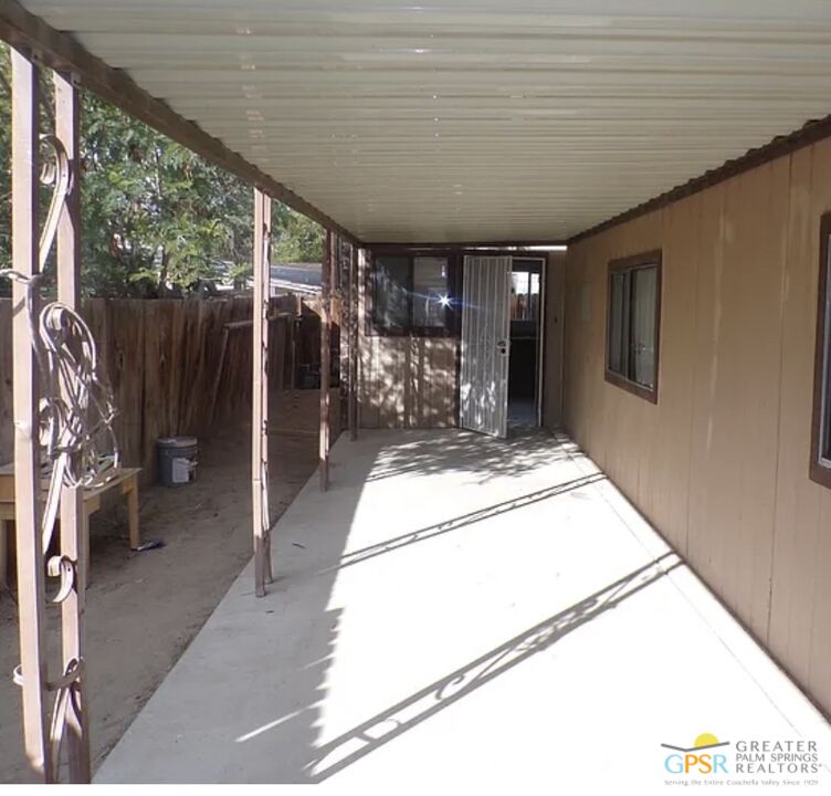 32407 Sonoma Circle, Unit A Thousand Palms, CA 92276 - Photo 2 of 5 a view of a hallway with a large window and chandelier