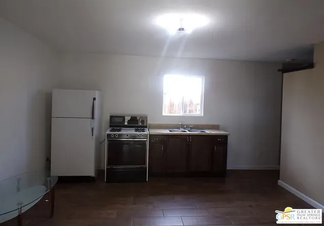 a kitchen with a stove and a refrigerator