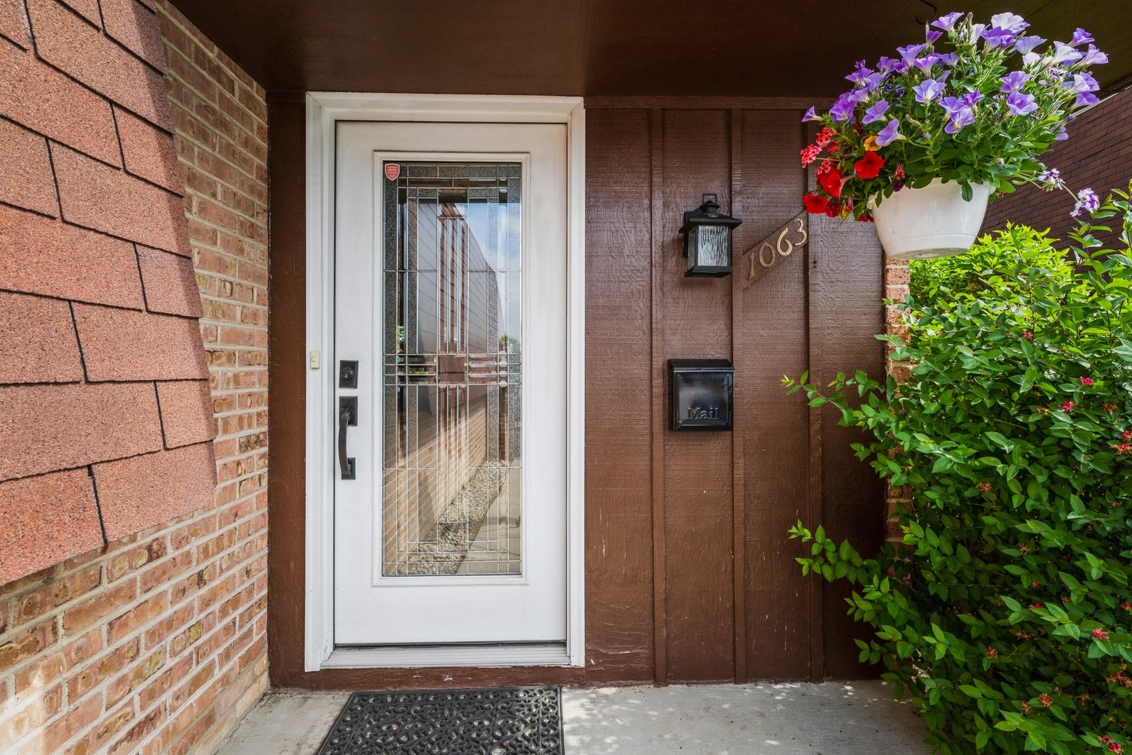 1063 Busse Highway Park Ridge, IL 60068 - Photo 2 of 16 a potted plant sitting in front of a door
