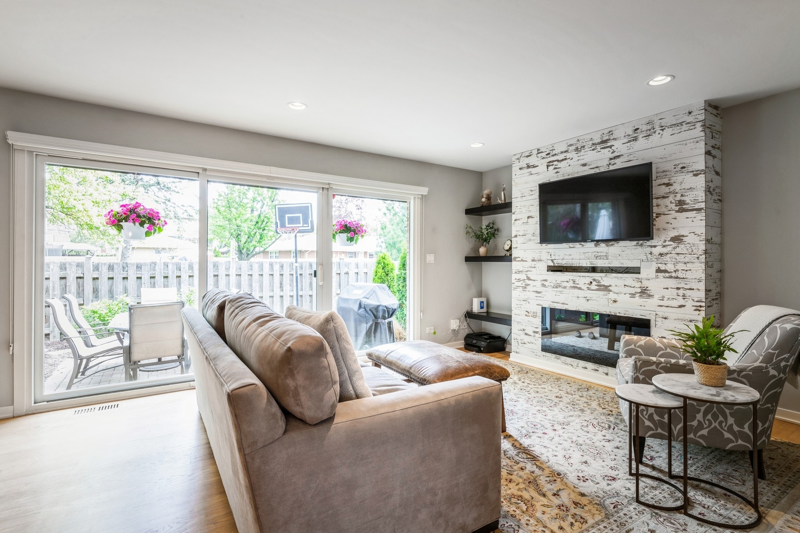 1063 Busse Highway Park Ridge, IL 60068 - Photo 3 of 16 a living room with furniture a fireplace and a flat screen tv