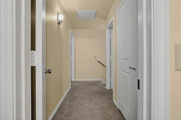 an empty room with a ceiling fan and a window