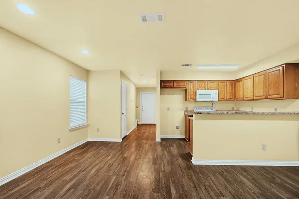 a view of a kitchen with wooden floor