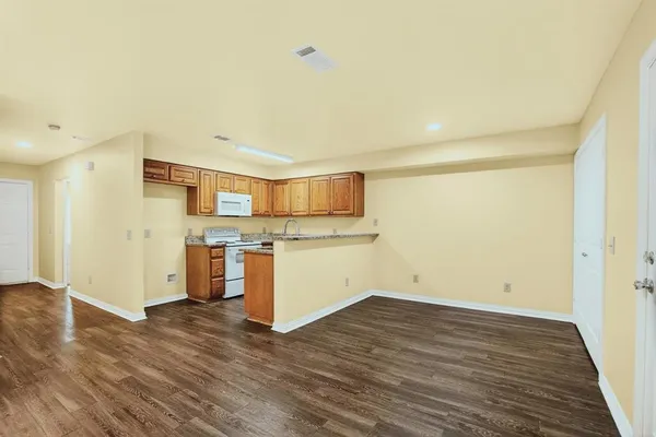 a kitchen with stainless steel appliances granite countertop a stove and a refrigerator