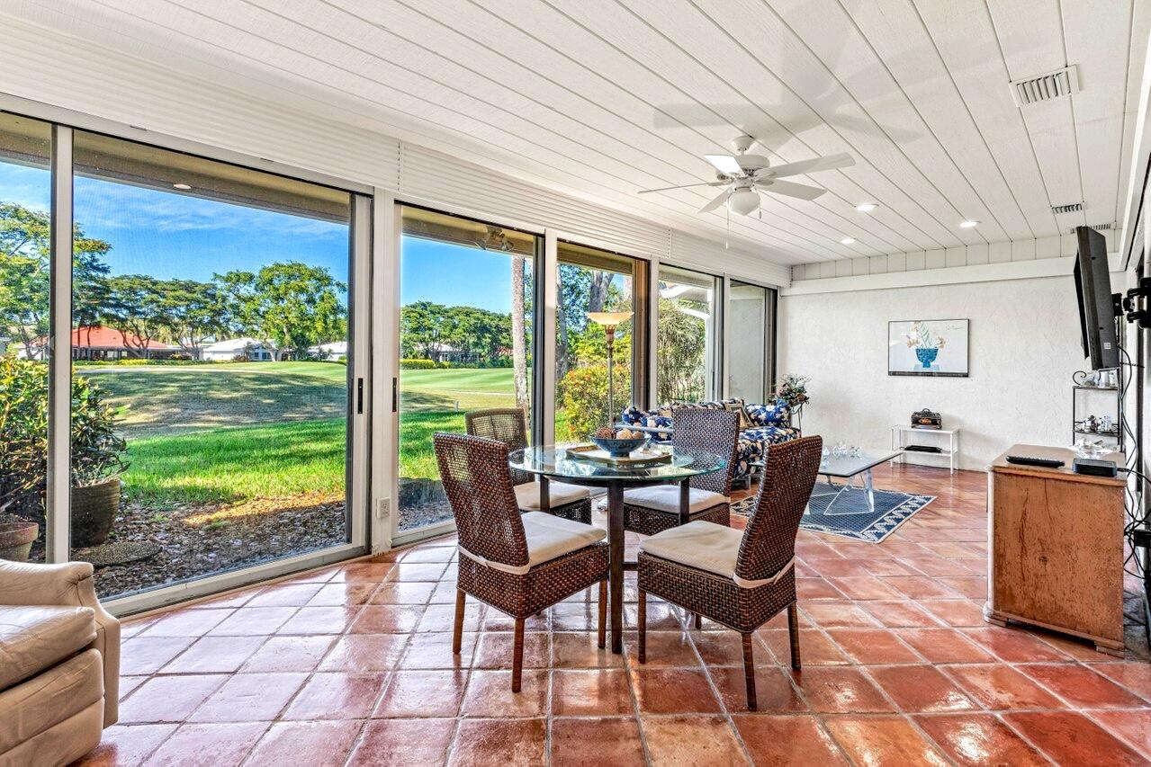 19 Glens Drive West Boynton Beach, FL 33436 - Photo 16 of 69 a dining room with furniture a chandelier and wooden floor