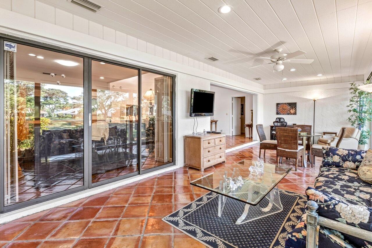 19 Glens Drive West Boynton Beach, FL 33436 - Photo 17 of 69 a living room with furniture a flat screen tv and floor to ceiling window