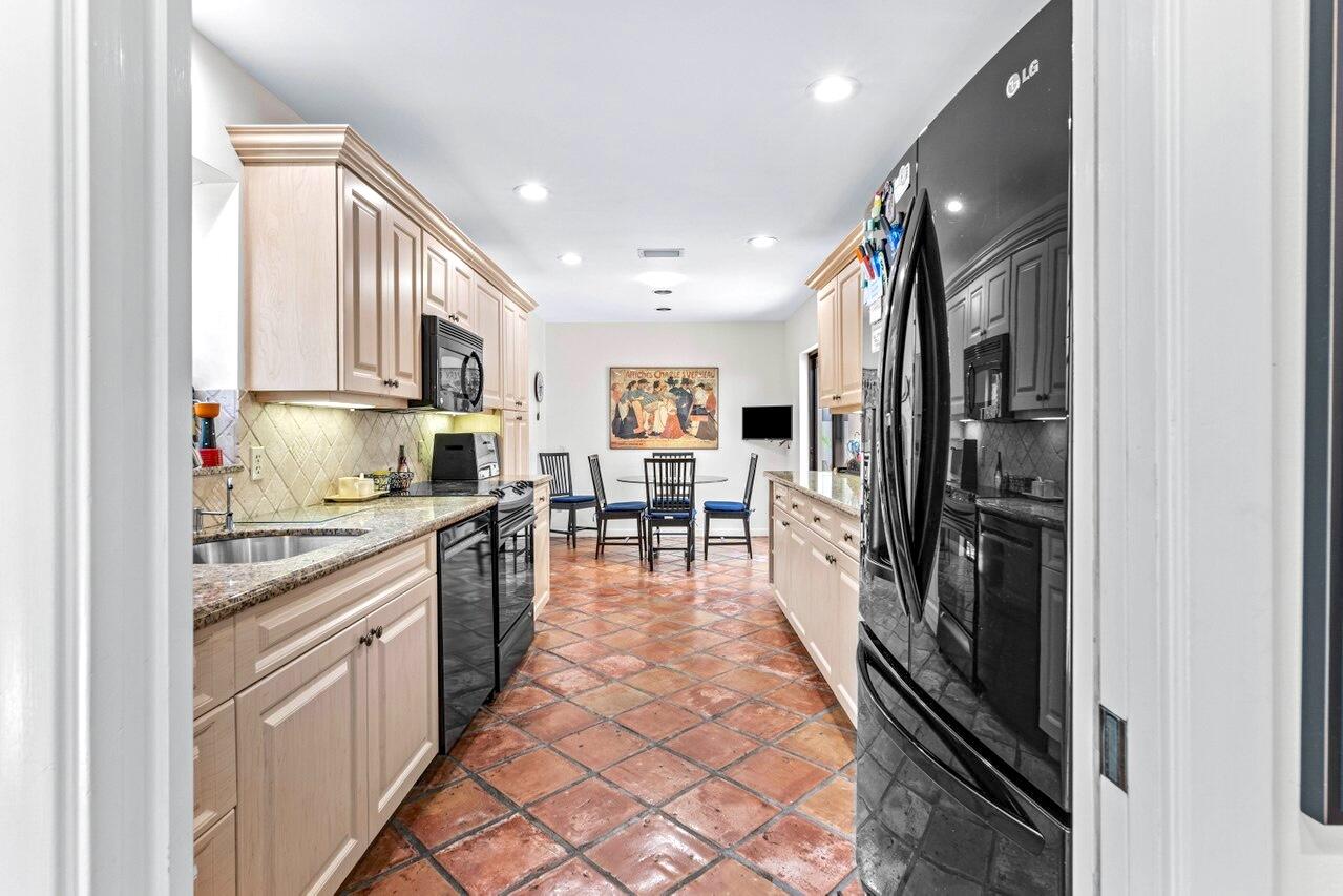 19 Glens Drive West Boynton Beach, FL 33436 - Photo 18 of 69 a kitchen with stainless steel appliances granite countertop a refrigerator and a sink