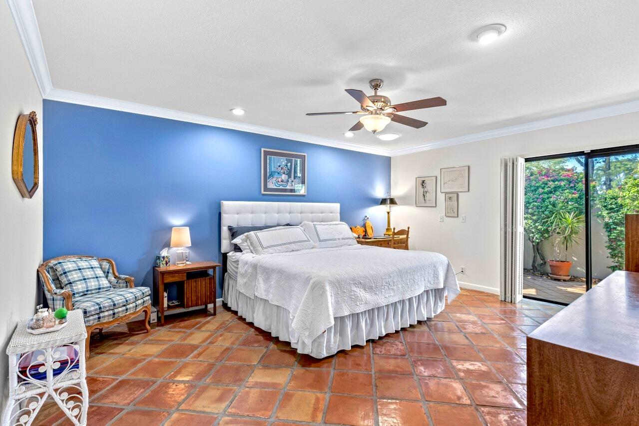 19 Glens Drive West Boynton Beach, FL 33436 - Photo 24 of 69 a bedroom with a bed and a chandelier