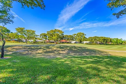 an aerial view of residential houses with outdoor space and swimming pool