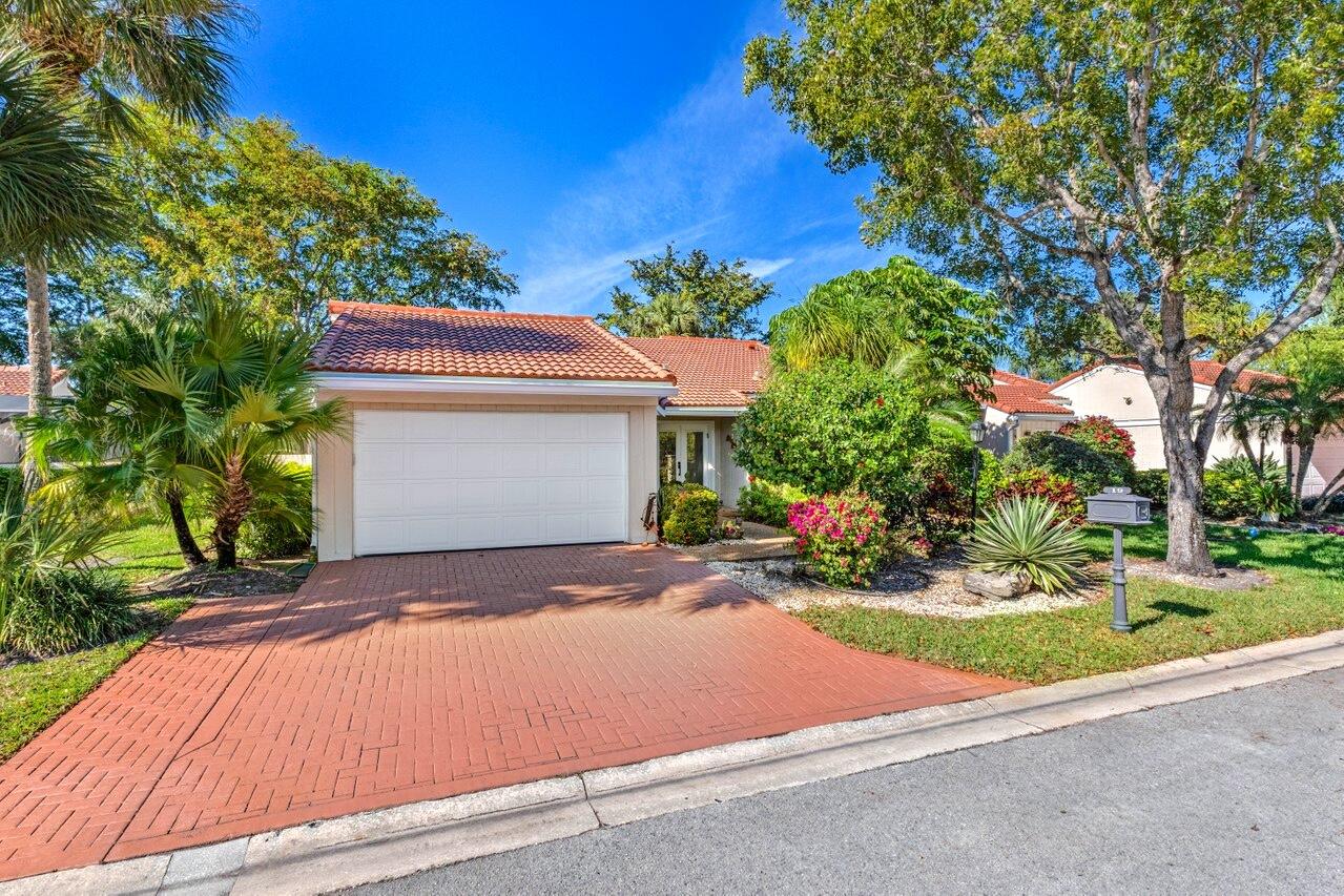 19 Glens Drive West Boynton Beach, FL 33436 - Photo 4 of 69 a front view of a house with yard and trees