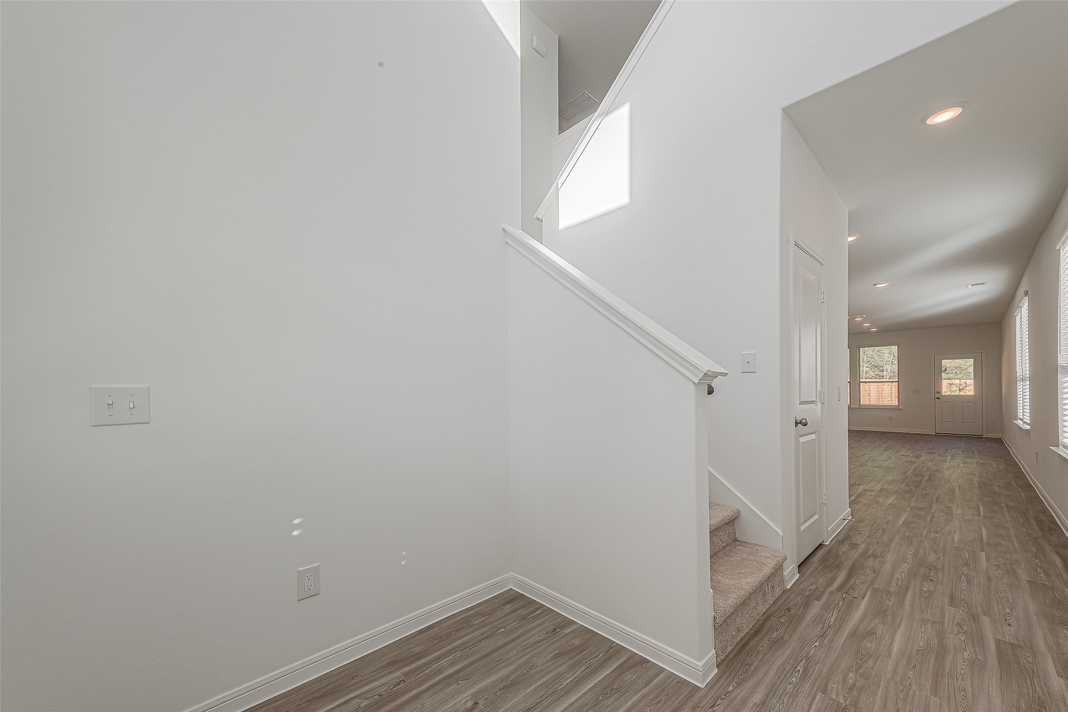 325 Maple Bark Trail Willis, TX 77378 - Photo 2 of 22 a view of a hallway with wooden floor and staircase