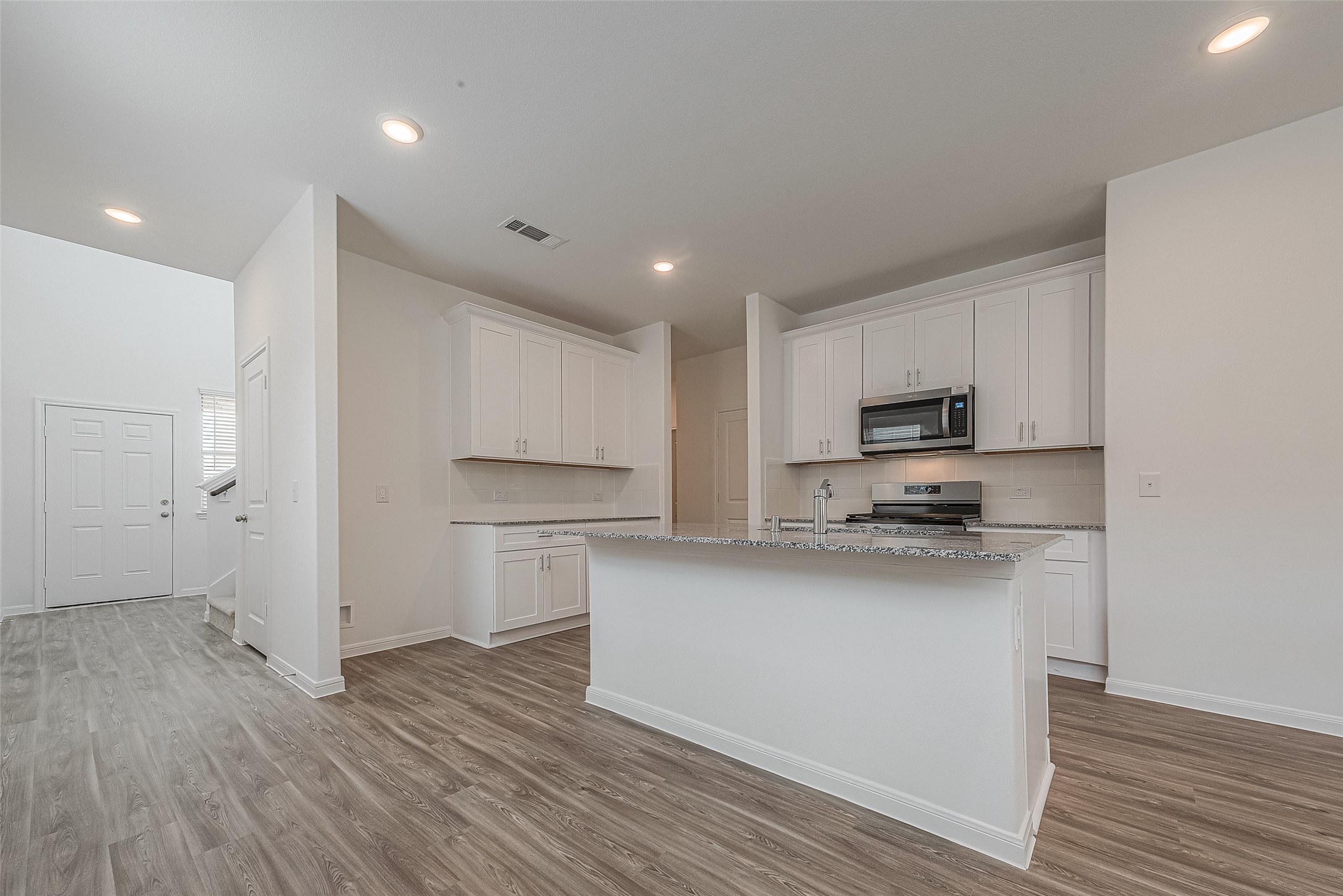 325 Maple Bark Trail Willis, TX 77378 - Photo 4 of 22 a kitchen with stainless steel appliances a refrigerator and a stove top oven