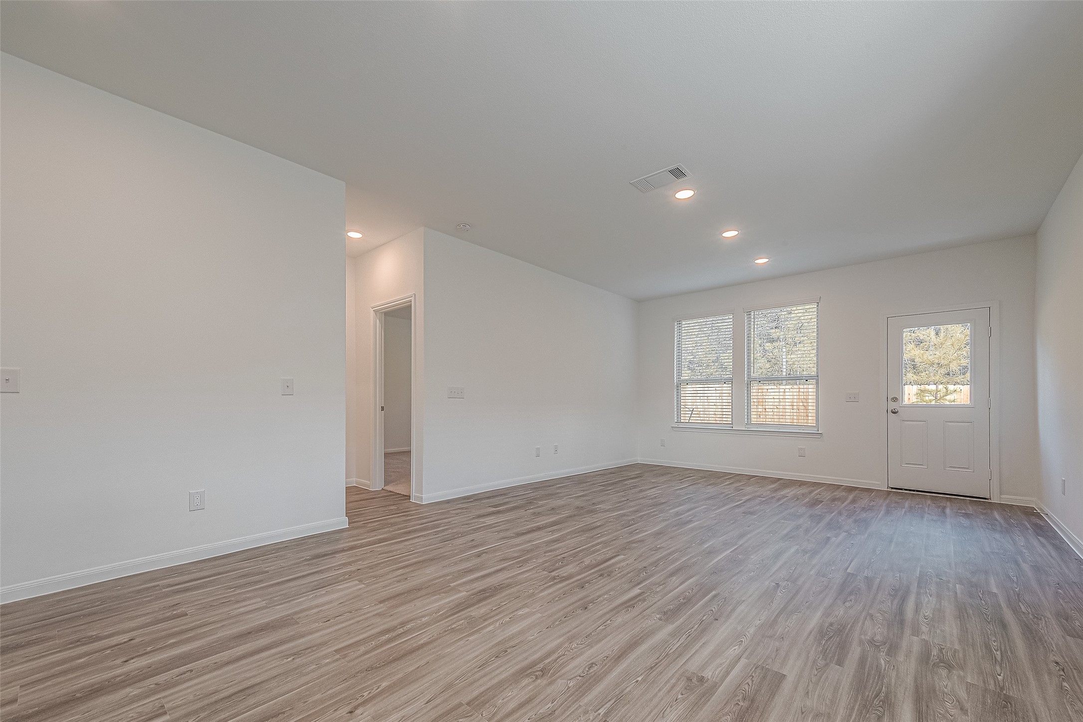 325 Maple Bark Trail Willis, TX 77378 - Photo 6 of 22 an empty room with wooden floor and windows