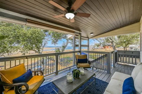 a balcony with furniture and wooden floor