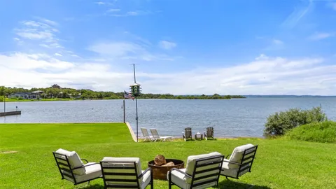 a view of a lake with couches in the patio