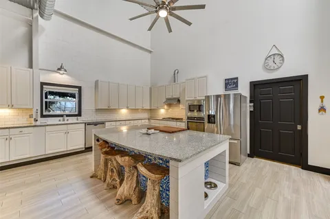 a kitchen with a stove a refrigerator and a microwave