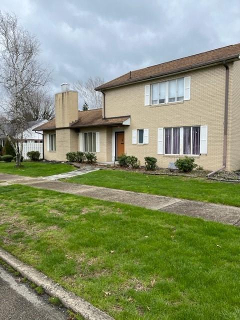 a front view of building with yard and green space