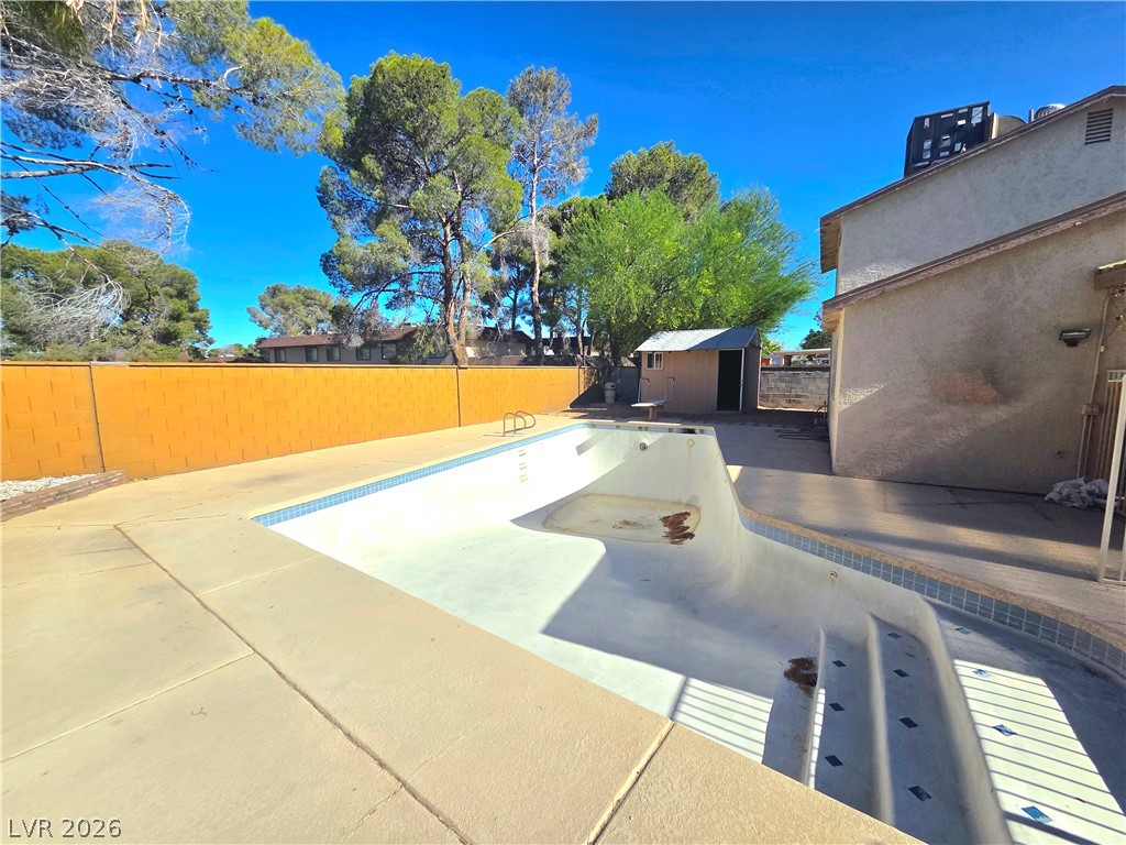 3648 Bronco Road Las Vegas, NV 89103 - Photo 18 of 24 A private backyard oasis awaits, featuring a refreshing in-ground pool and ample concrete patio space.